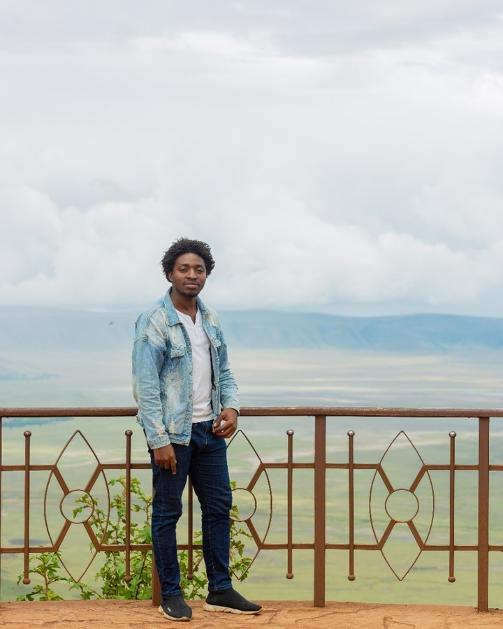 A picture of Mirambo Paul standing at the Ngorongoro view point.